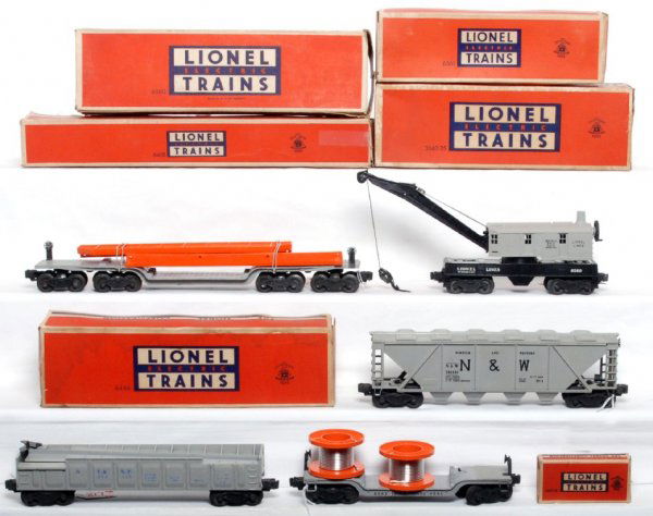 Lionel 6418, 3562-25, 6446, 6561, 6560 OB: Lionel 6418 sixteen wheel flat with girders, 6560 gray cab crane, 3562-25 gray barrel car, 54-6446 Norfolk and Western hopper and a 6561 reel car. Reel car is missing strap, barrel car is missing man.