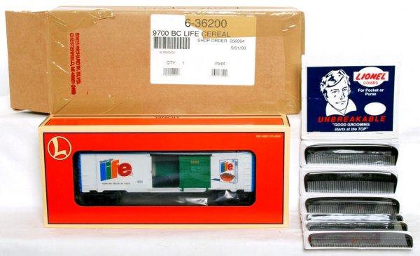 Lionel 36200 Quaker 9700 Life Cereal boxcar: Lionel 36200 Quaker 9700 Life Cereal boxcar in original box, C9-10. Also included is a neat novelty/curiosity item, Lionel combs on a display/separate sales peg/hook hanging package.