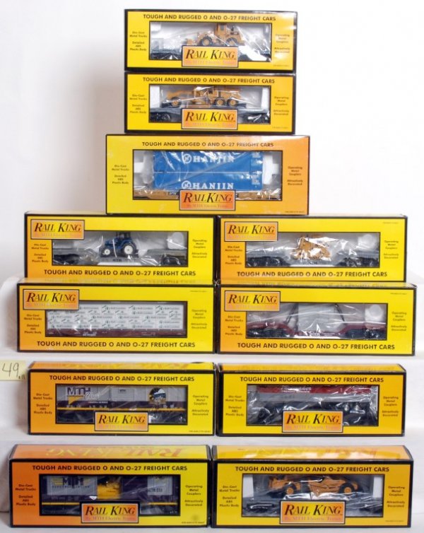Eleven MTH Rail King freight cars in OB: Eleven MTH Rail King freight cars in original boxes, C8-10. 30-7611 flat w/Ertl tractor, 30-7612 flat w/transformer, 30-7636 Southern Pacific flat w/bulkheads, 30-7618 flat w/Ertl bull dozer, 30-74223