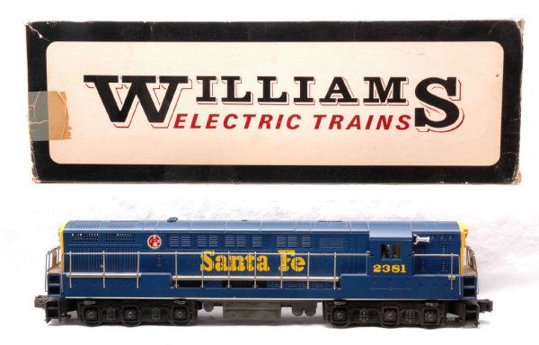 Williams Santa Fe Train Master FM Diesel Boxed: Williams Santa Fe blue and yellow Train Master FM diesel with cab no. 2381 in OB. The diesel is C7. OB has tape on one end.
