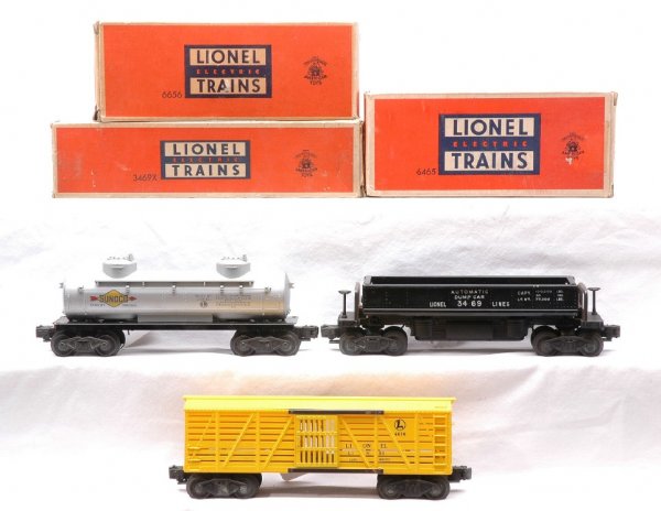 Lionel 3469X Dump 6465 Sunoco 6656 Stock LN OBs: Lionel postwar 3469X automatic dump car, 6465 Sunoco two dome tank and 6656 yellow stock car in OBs. The 6465 tank car has some paint chips on one end of the the frame. All cars are C8. The OBs have a