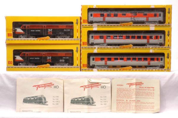 Fleischmann HO NH 1341 1341 1414 1414 1415 MIB: Fleischmann HO scale two 1341NC New Haven diesels in OBs with instruction sheets. The hand rails on the diesels have corrosion, otherwise, C9. Also included are three New Haven passenger cars; two NC1