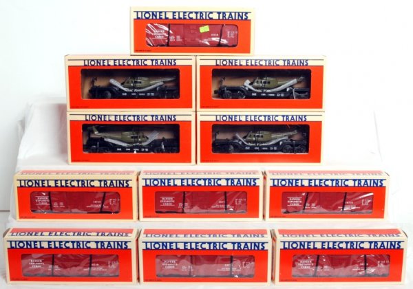 Four Lionel 16952 and seven 16719 in OB: Four Lionel 16952 U.S. Navy flatcars with Ertl helicopter and seven 16719 exploding boxcars, in original boxes, C9-10. A couple boxes have a price sticker.