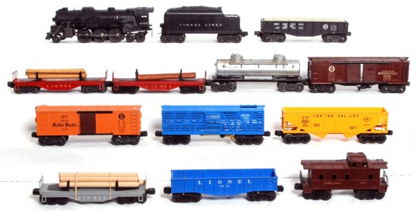 Lionel 2026 and 6466WX with eleven freight cars: Postwar O gauge Lionel 2026 steam loco and 6466WX tender with 2452 Pennsylvania hopper, three unnumbered log flatcars, 6176 Lehigh Valley hopper with glue repaired shell, 3376 Bronx Zoo giraffe car, 2