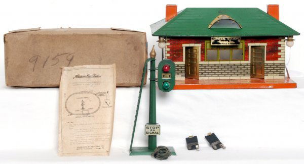 American Flyer Central Station and 2206 signal: American Flyer prewar Central Station C6 and 2206 narrow gauge twin light crossing signal in original box with original instructions sheet and two track terminals C7. Box shows light wear.
