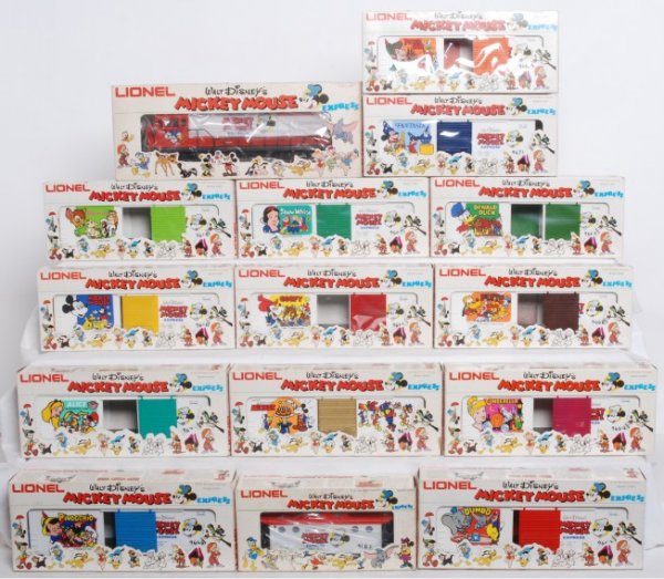 Lionel Mickey Mouse Express Set: Lionel Mickey Mouse Express Set. Includes 8773 Engine in OB. Engine includes all paper work and looks unrun. OB has shelf wear. C8-C9. Boxcars include 9671 Fantasia, 9672 50th Anniversary, 9664 Cinder