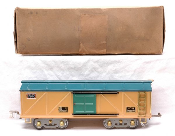Am Flyer 4018 Rookie Tank Automobile Car LN OB: American Flyer prewar wide gauge 4018 Rookie tan automobile car with turquoise roof, green door and gray flex trucks in OB. Overall the paint is clean but the roof has a rub mark and a couple of spots