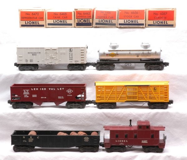 Lionel Freights 6472 6656 6465 6456 6462 6357 OBs: Lionel postwar freight cars; 6472 refrigerator car, 6656 stock car, 6465 Sunoco tank, 6456 red hopper, 6462 black NYC gondola with barrels and 6357 caboose all in OBs. Cars are C7-8. OBs have most fla