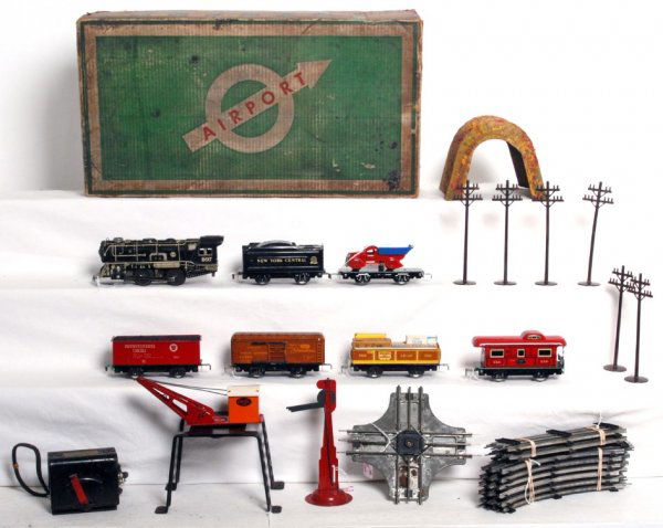 Marx boxed Airport freight set with accessories: Marx set with the Airport set box. 897 litho steam loco with NYC tender, 552G gondola, PRR hopper, CNW boxcar, flat with original dump truck and 556 NYC caboose. Trains are in the C7 area. Set include