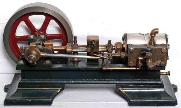 Large cast iron single cylinder live steam engine: Large cast iron single cylinder live steam engine. This impressive engine measures approximately 20 inches long overall, 10 inches at widest points and 8-3/4 inches tall at brass fitting on top of cyl