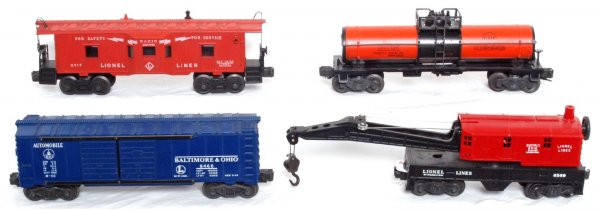 Lionel 6315, 6517, 6468, 6560 postwar freight: Postwar Lionel O gauge freight cars, 6315 Gulf tank, 6517 bay window caboose, 6468 Baltimore and Ohio double door automobile car and unrun 6560 operating work crane, some tiny spots of light surface r