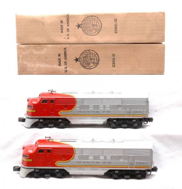 Lionel 2383 Santa Fe F3 AA Diesels LN Boxed: Lionel postwar 2383 Santa Fe F3 AA diesels in OBs. Diesels have minor box rubs. The silver is clean and both decals are intact, C7-8. OBs have all flaps attached. There is moisture damage and staining