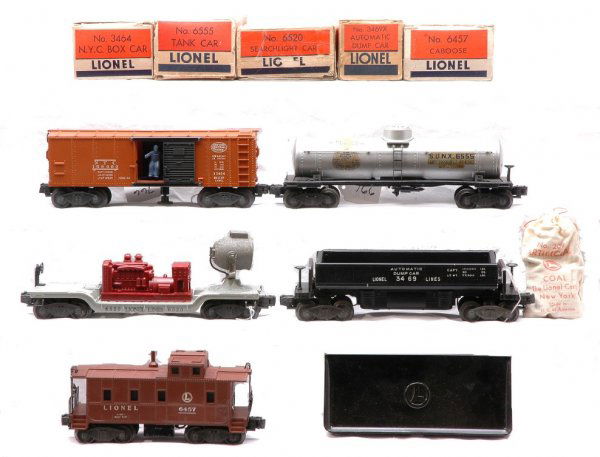 Lionel Freights 3469X 6520 3464 6555 6457 Boxed: Lionel postwar freight cars from set no. 2151W; 3469X dump car with 207 bag of coal and 160 bin, 6520 maroon searchlight car, 3464 NYC boxcar, 6555 Sunoco tank and 6457 caboose with broken stack in OB