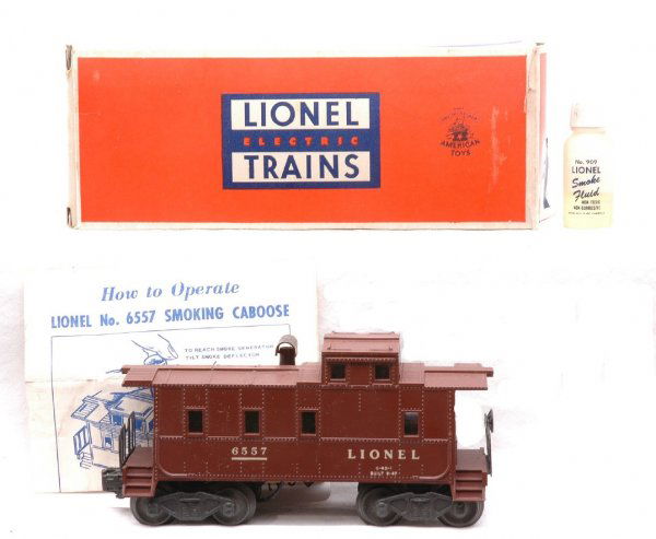 Lionel 6557 Illuminated Smoke Caboose LN OB: Lionel postwar 6557 illuminated smoke caboose in OB with instruction sheet and bottle of 909 smoke liquid. The caboose has a couple of minor chips on roof, otherwise, C8. The OB is missing one interio
