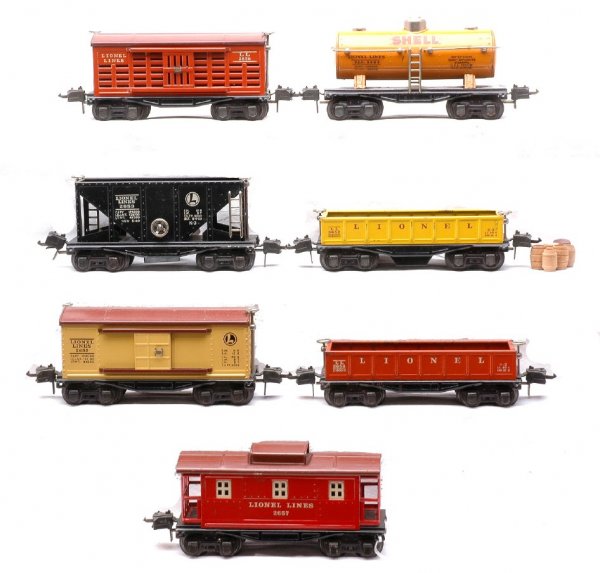Lionel Cars 2652 2653 2654 2655 2656 3652 2657: Lionel prewar O gauge seven freight cars; 2652 burnt orange gondola, 2653 black hopper, 2654 orange Shell tank, 2655 cream boxcar with a Tuscan roof, 2656 burnt orange cattle car with a Tuscan roof, 3