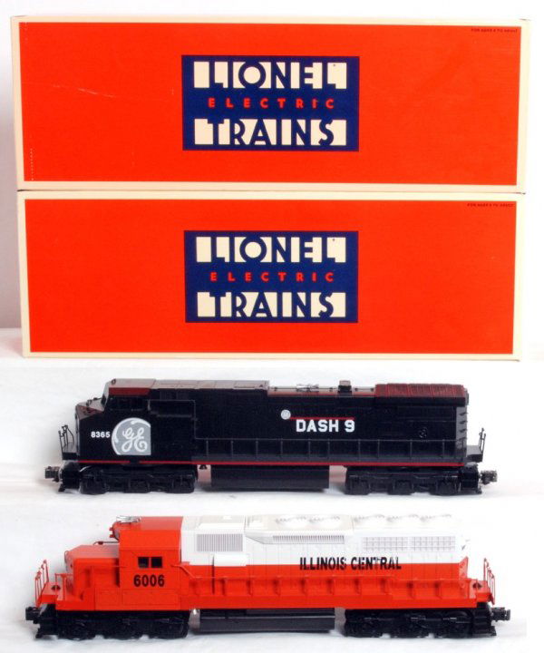 Lionel 18210 I.C. SD-40 and 18226 G.E. Dash-9 demo: Lionel O gauge 18210 Illinois Central SD-40 and 18226 General Electric Dash-9 demonstrator, diesel locomotives in original boxes, C8. Boxes show little wear.