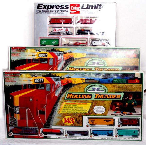 Three HO diesel freight sets in OB Bachmann: Two Bachmann Item No. 00603 Rolling Thunder Santa Fe diesel freight set. The Train Set for Coke, Markatron, Inc. Coke diesel freight set. Markatron and one Rolling Thunder sets are factory sealed, C9-