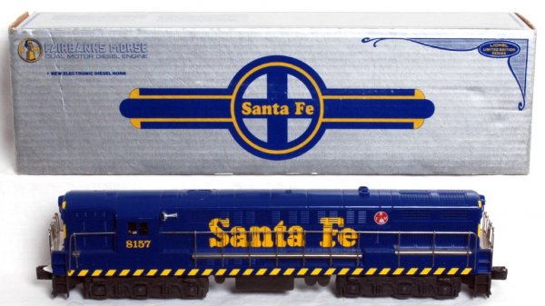 Lionel No. 8157 Santa Fe FM Trainmaster in OB: Lionel O gauge No. 8157 Santa Fe Fairbanks Morse Trainmaster in original box with no paper work. Train has a thin scratch on one cab side, otherwise rest of train should clean C8 area. Box shows littl