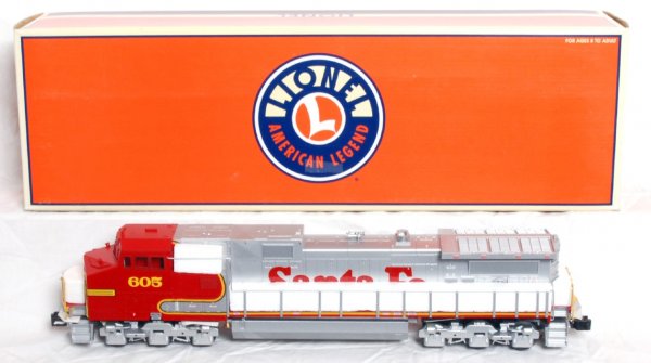 Lionel No. 18254 Santa Fe Dash-9 w/TMCC in OB: Lionel O gauge No. 18254 Santa Fe Dash-9 diesel locomotive with TMCC, RailSounds and fan driven smoke unit in original box. Train looks much better but is graded C8 due to having been run. Box shows n