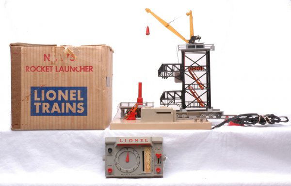 Lionel Postwar 175 Rocket Launcher Boxed: Lionel postwar 175 rocket launcher with instruction sheet in OB. One side of the metal base has rusted and the cord is brittle, otherwise the accessory is C7. The OB is worn.