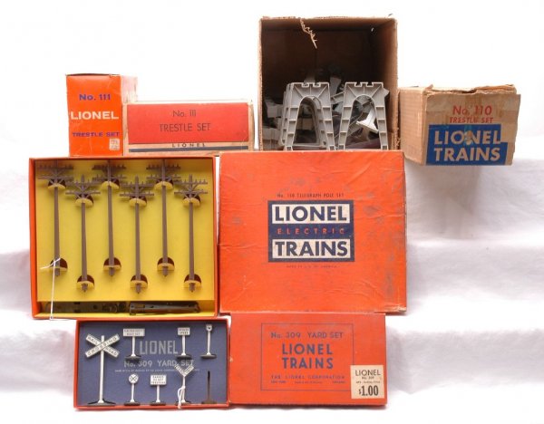 Lionel Accessories 150 309 110 110 111 111 Boxed: Lionel postwar 150 telegraph pole set and a 309 yard set missing one sign, both in orange OBs. Both sets are C7-8. The inserts on the 150 and 309 are bright and clean. The lid on the 150 OB has some s