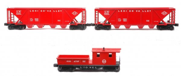 Lionel Freights 2-6436 LV Hoppers 6130 Caboose: Lionel postwar freight cars; two 6436 red Lehigh Valley quad hoppers and a 6130 ATSF work caboose. The hoppers are C8 and the caboose is C7.