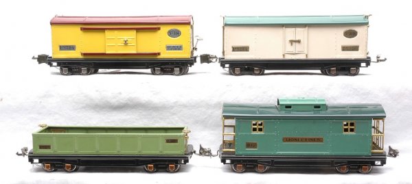 Lionel Freight Cars 812 814R 814 817 Restored: Lionel prewar O gauge freight cars; 812 apple green gondola with a restored frame, 814R cream reefer with peacock roof, 814 yellow automobile car with maroon roof and 817 peacock green caboose with da