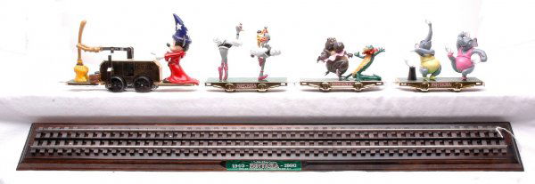 Pride Lines Walt Disney Fantasia 1940-1990: Pride Lines Walt Disney Fantasia 1940-1990 handcar with three cars on a wooden display board. The cars have minor tarnishing on the sides, otherwise the handcar and cars are C8.