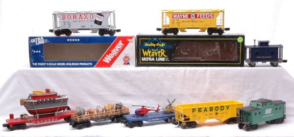 Lionel 6801 w/Boat Flats Cabooses Weaver Hoppers: Lionel postwar 6801 flatcar with a homemade ocean liner, Lionel 9325 Norfolk & Western flatcar with animals, 9026 Republic Steel flatcar with helicopters, 9067 Atchison Topeka & Santa Fe caboose and a