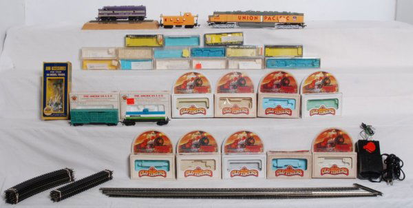 Lot of N scale and HO scale trains and track: Lot of N scale and HO scale trains and track. Tyco and Bachmann HO diesel trains and freight cars. AHM Telephone poles and other items in an AHM box. Twelve curved and ten straight sections of Atlas H