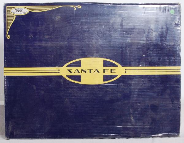 Sealed Lionel Santa Fe 11713 set: Lionel 11713 Santa Fe Dash 8-40B freight set factory new in OB, C10. A small section of cellophane is torn on back and on corners. OB has some shelf wear. Has price sticker on celo.