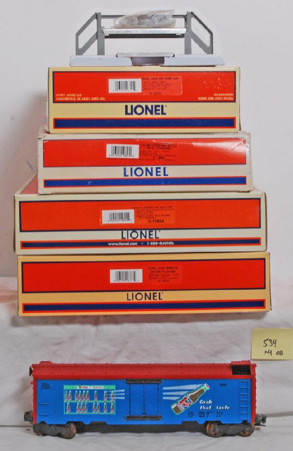 4 Lionel operating cars, cola, milk, dump, cattle: Lionel operating cars in OBs. 19828 Chicago and Northwestern operating cattle car and stock yard. C9-10. 19894 HoodÕs operating milk car. C9-10. Lionel Lines 26721 ore dump car OB has faded end. C9-1