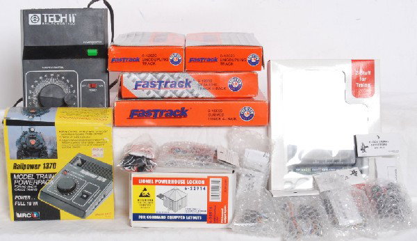 Lionel Fastrak, Z stuff signals, MRC trans, Etc: Lot includes Lionel 12033 Fastrack curved 4 pack and 12032 straight 4 pack. C8, some light rust on one or two rails. Two 12020 Uncoupling tracks in OBs. One OB has slight water damage. C8-9. MRC Railp