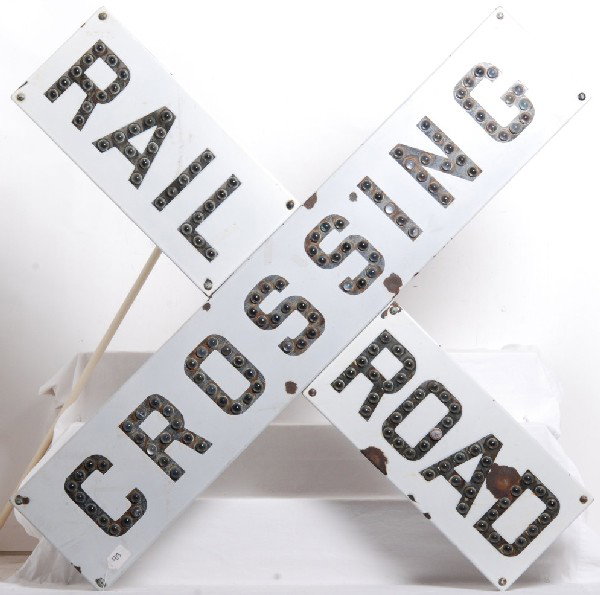 Porcelain US&S Crossbuck with cat eye reflectors: Union Switch and Signal porcelain railroad crossbuck with cat eye reflectors. Crossbuck is in good condition. Has about 7 areas on the face where the porcelain has chipped away. Largest area is about 