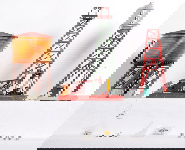 Lionel No. 38 op. water tower, 455, 193: Postwar Lionel O gauge No. 38 operating water tower, 455 oil pumper and derrick, 193 industrial water tower. 38 has melt marks to interior of tank, cracks to tank and repairs to tank, 455 has repainti