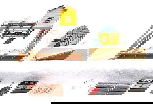 Am Flyer 779 Oil Drum Loader 787 Log Loader: American Flyer S gauge 779 oil drum loader with controller and reproduction barrels. Also included is a 787 log loader with wooden logs and controller. Both accessories are C6.