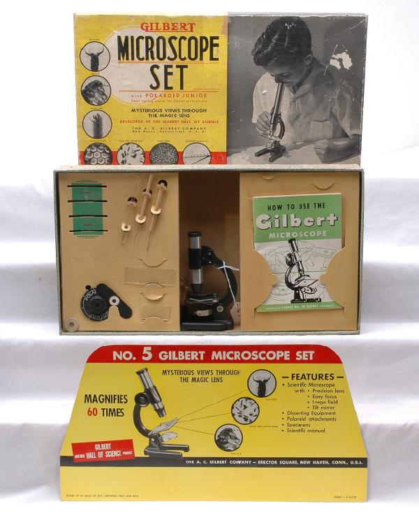 A. C. Gilbert no. 5 Microscope Set Boxed: A. C. Gilbert no. 5 microscope set with Polaroid Junior microscope, accessories and instruction book in cardboard OB. The set includes a cardboard advertising stand which is very clean with bright col