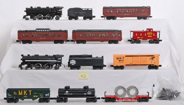 Lot of Lionel LTI trains and 027 track: Lionel LTI era trains. Two locos are Lionel 8628 MKT and 8602 Pennsylvania. Pennsylvania passenger cars included are 16000 vista, 160001 coach and 16003 observation. MKT cars include 16537 caboose, 16