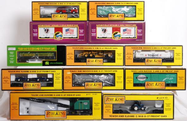 12 MTH and Railking cars NYC, Texaco, Etc.: MTH and Railking O gauge freight cars in OBs. MTH Premier cars include two 20-93092 American freedom boxcars. Railking cars include 30-7371 John Deere tank car, 30-7660 MTH flat with 65Õ Shelby, 30-7