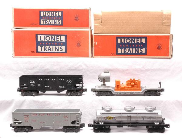 Lionel Freights 6456-25 6520 2456 w/OBs 6415: Lionel postwar freight cars; 6456-25 gray Lehigh Valley hopper with red lettering, 6520 searchlight car with orange generator, 2456 black Lehigh Valley hopper with original cardboard insert all in OBs