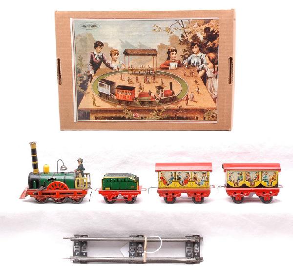 Clock Work Litho Pass Set Made in Western Germany: Clock work lithographed passenger set made in Western Germany containing; loco, tender, two coaches and two pieces of straight track in reproduction box. The set is C6.