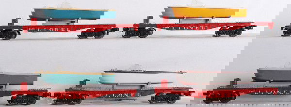 Lionel three 6801 flatcars and one 6819 flat w/boa: Three postwar O gauge Lionel 6801 flatcars and one 6819 flatcar. Flatcars look C6-7. Three 6801-60 boats, two blue and one yellow. One brown boat. One 6801 has a loader holder missing two ears. One or