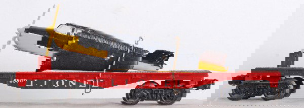 Lionel No. 6800 flatcar with Beech craft Bonanza y: Postwar O gauge Lionel No. 6800 flatcar with Beech craft Bonanza yellow airplane with black top, surface rust rivet heads, O/W should clean C7 area. One original load restraint.