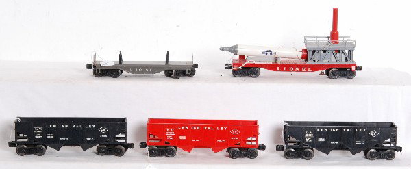 Lionel 6076, 6476, 3413, flatcar and 6476: Postwar O gauge Lionel No. 6076 and two 6476 Lehigh Valley hoppers, 3413 Mercury Capsule car with rocket and original load restraint and an unnumbered dark gray pipe/log car. 3413 is missing rear sect