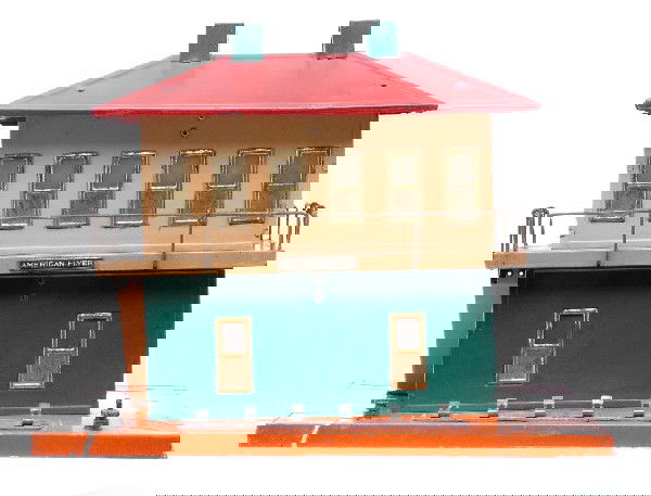Am Flyer Prewar 108 Switch Tower House: American Flyer prewar wide gauge 108 switch tower house with orange base, green lower building section, red-handle knife switches and roof and green chimneys. Underneath the base of the switch tower h