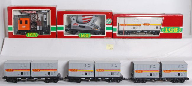 6 LGB freight cars 4069, 4055, 4049: LGB G Scale freight cars in OBs. Six total including four 4069 flats with trailers, 4055 cement mixer cars, and 4049 spotlight car. Cars are generally C8, two OBs on 4069 have been moisture damaged, C