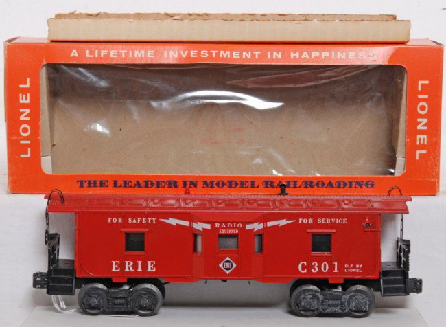 Lionel No. 6517-75 Erie C301 bay window in OB, Mi: Postwar O gauge Lionel No. 6517-75 Erie bay window caboose C301 in original box with insert, C10. OB has very small tear/puncture to cello and -C301 written in ink on one end flap. Box is clean and br