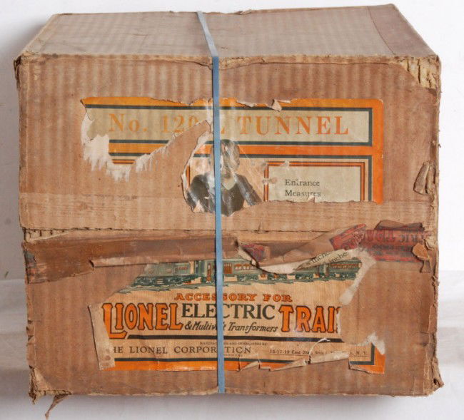 Super nice Lionel No. 120L tunnel in OB: Prewar Lionel No. 120L tunnel in original box. Tunnel has a small spot of flaking paint on one side about the size of a quarter and a very small sized spot of wax paper stuck on other side. Illuminate
