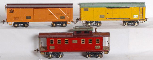 Three Ives-American Flyer transitional freight ca: Three prewar wide/standard gauge Ives - American Flyer transitional freight cars. Two 20-192 reefers and a 20-195 caboose. Cars have missing trim, repainting, redecorated. Trains look C6 area.