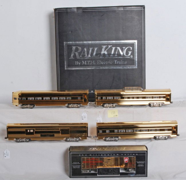 Railking Pennsylvania 30-6707 gold passenger set: Railking O Gauge modern Pennsylvania 30-6707 four car gold plated passenger set and 30-7446 Pennsylvania gold boxcar in OBs. Passenger set includes 2000 EA baggage, J. Lionel Cowen coach, Harry Ives V